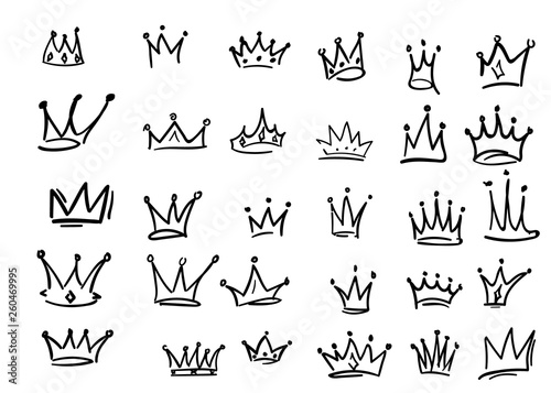 Set of iconic hand drawn crowns. Luxury collection of inky black outline symbols of leadership, success, power and riches or wealth. Isolated elements for branding and identity.