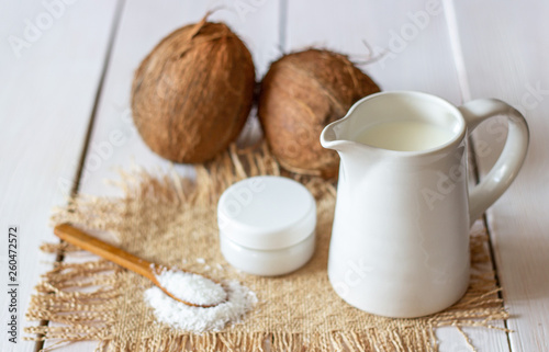 Coconuts and coconut milk. Wooden background.