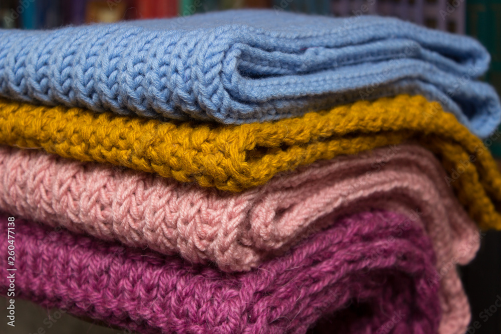 Handmade wool items folded, close-up photo. Handmade wool items folded, close-up photo.