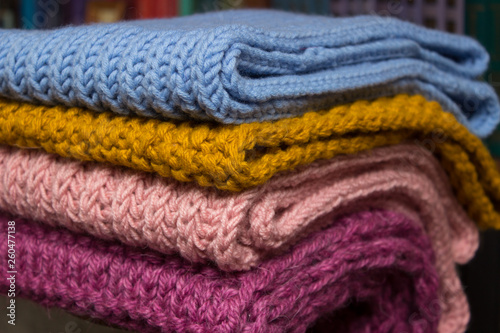  Handmade wool items folded, close-up photo.