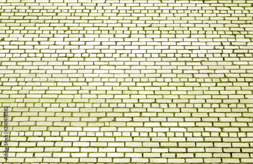 Pattern of brick wall with blur effect in yellow tone.