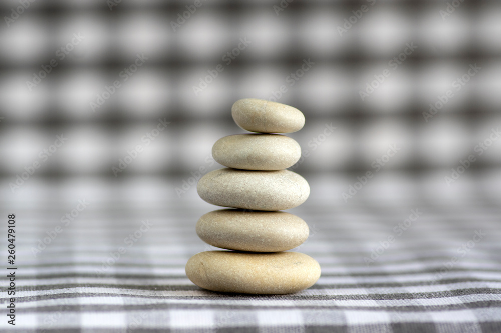 Harmony and balance, cairns, simple poise stones on white gray checkered background, rock zen sculpture, five white pebbles Harmony and balance, cairns, simple poise stones on white gray checkered background, rock zen sculpture, five white pebbles