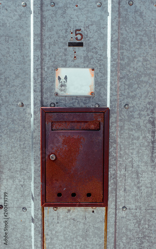 Rusty mail box on metal outdoor galvanized iron door