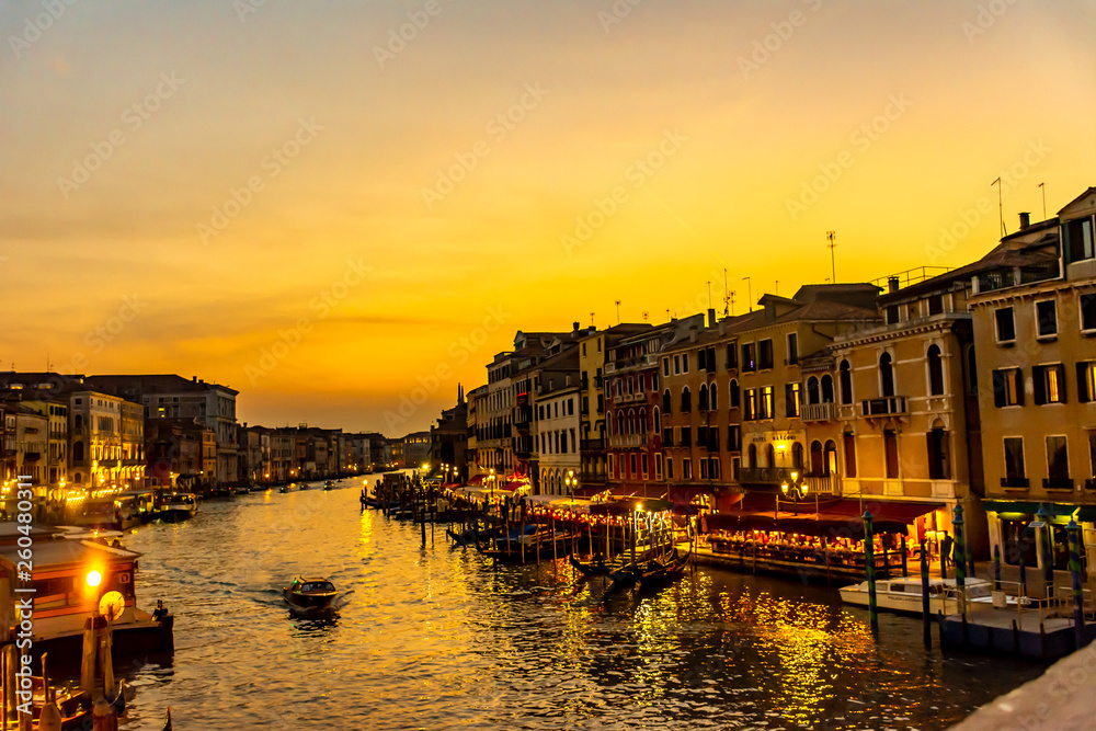 Italy, Venice, view of the Grand Canal at sunset with boats and gondolas.