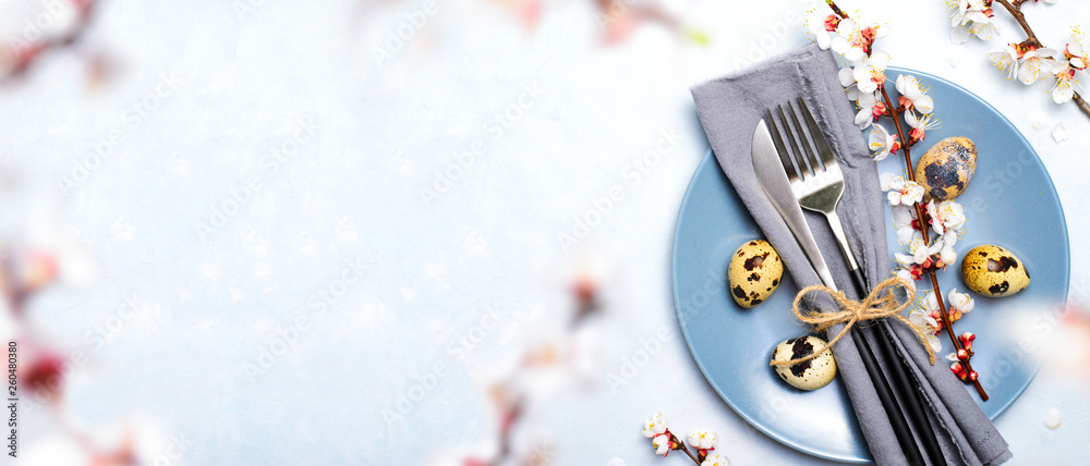 Easter Table Setting with Quail Eggs and Branches in Blossom, Spring Holidays Background Easter Table Setting with Quail Eggs and Branches in Blossom, Spring Holidays Background