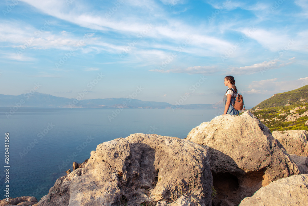 Young beautiful girl traveling along the coast of the Mediterranean Sea.