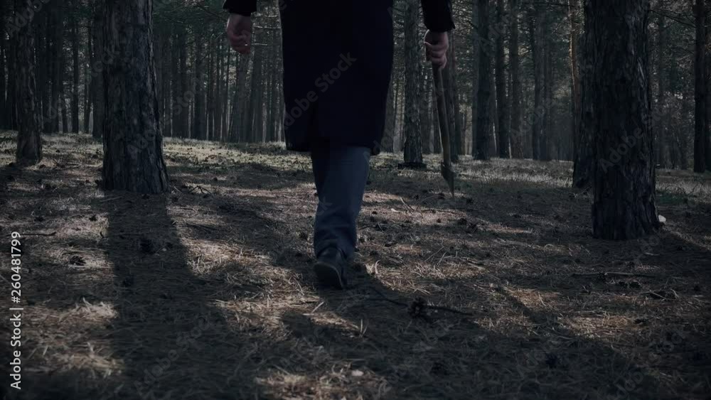 Crazy maniac walks in forest with ax and looking for victim. Horror in park Crazy maniac walks in forest with ax and looking for victim. Horror in park