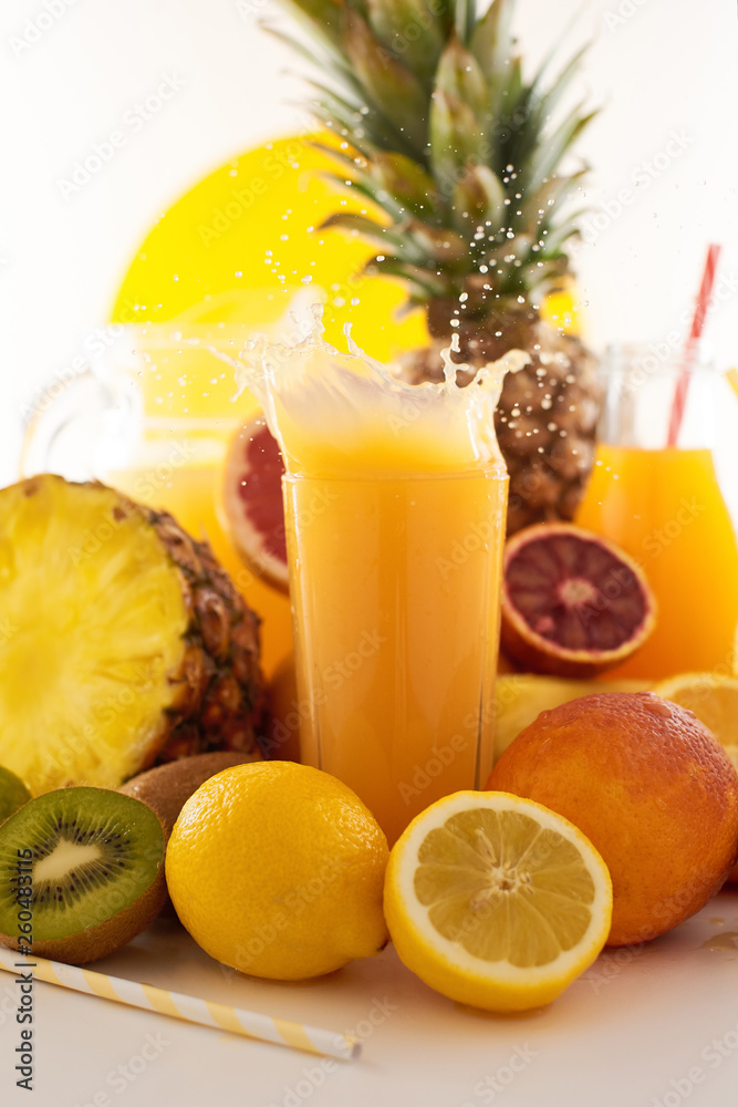 Fresh juice dynamic splash. A glass of fruit drink and fruits on a white background. Delicious, tasty, sweet summer set. Fresh juice dynamic splash. A glass of fruit drink and fruits on a white background. Delicious, tasty, sweet summer set.