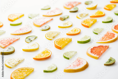 Juicy fresh sliced citrus fruits on white surface