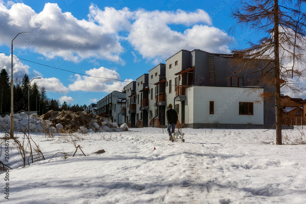 Сity dweller with clear water in canisters on his dolly
