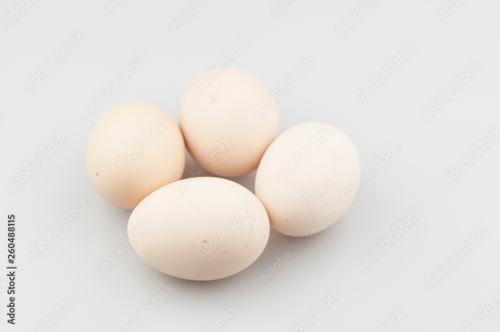 Brown chicken eggs in a grey carton box
