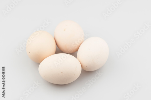 Brown chicken eggs in a grey carton box