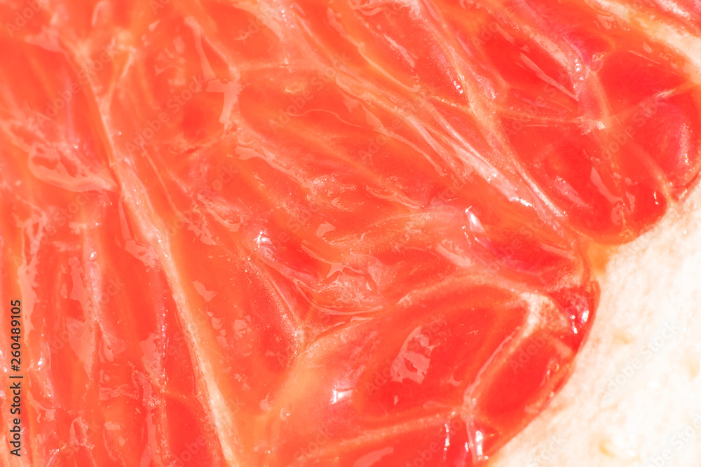 Bright juicy grapefruit pulp close-up. High-quality image is suitable for topics: healthy lifestyle, vitamins, proper nutrition, diet, summer, fresh juices. Background fruit texture.