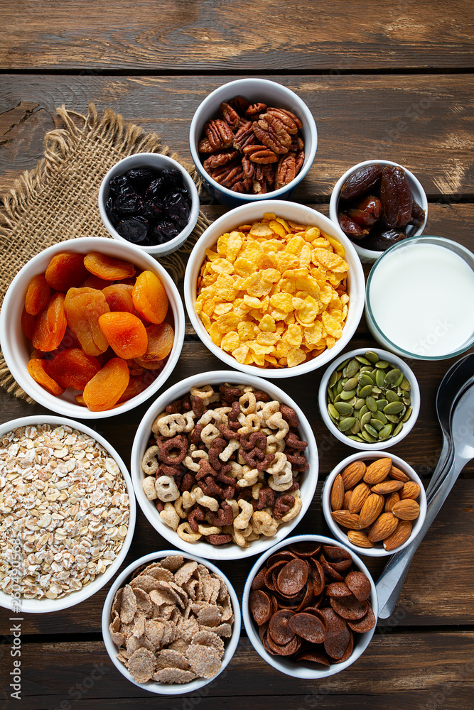 various cereals, nuts and dried fruits on wooden surface various cereals, nuts and dried fruits on wooden surface