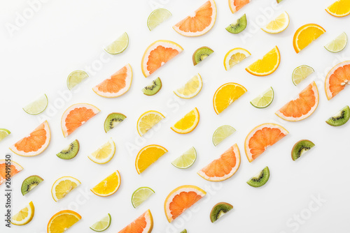 Flat lay with juicy cut fruits on white surface