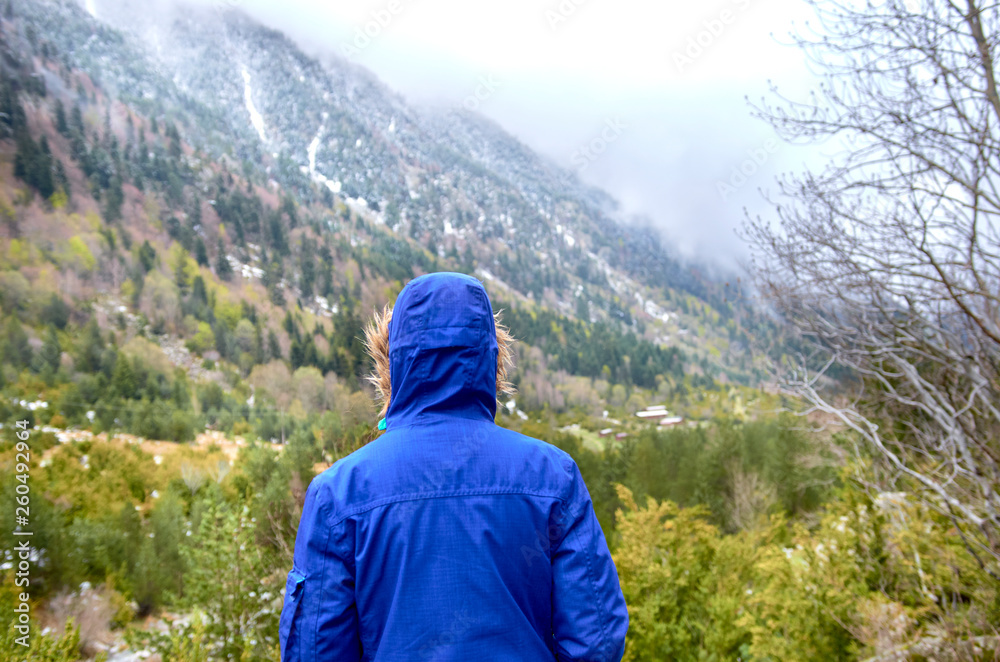 Woman with blue jacket back to the Catalan Pyrenees, Spain, Beautiful mountains Woman with blue jacket back to the Catalan Pyrenees, Spain, Beautiful mountains