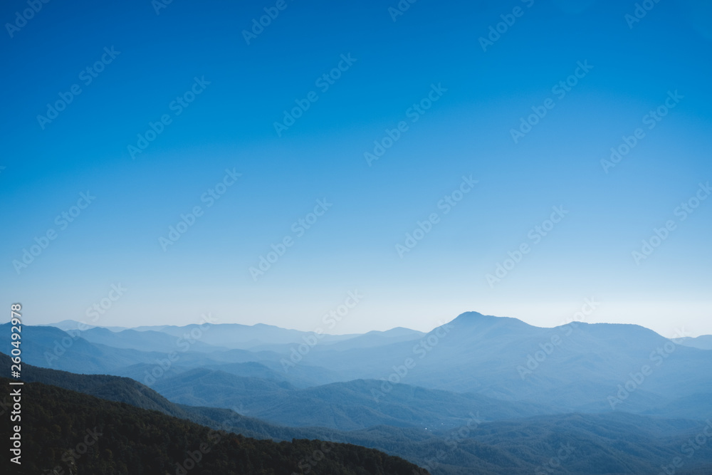 Beautiful blue landscape with white fog mountains.