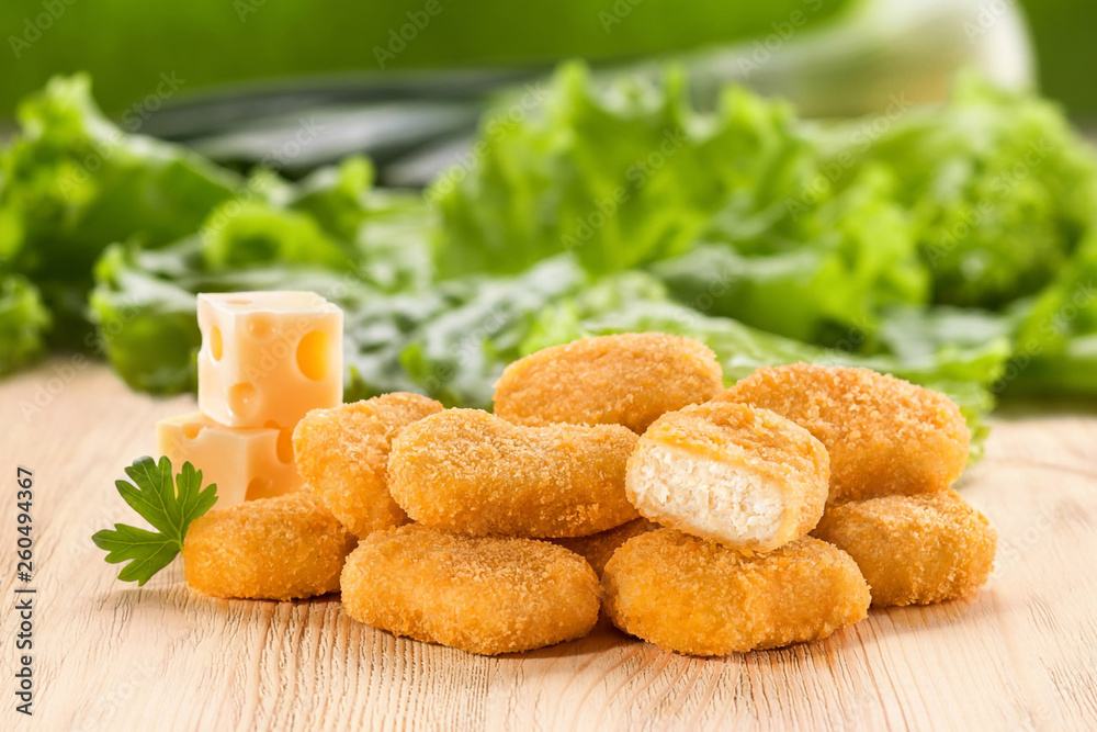 Chicken nuggets with cheese on a wooden table. Chicken nuggets with cheese on a wooden table.