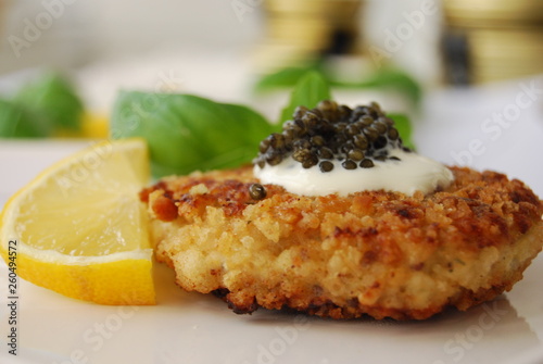 black caviar served on a dish with sour cream 