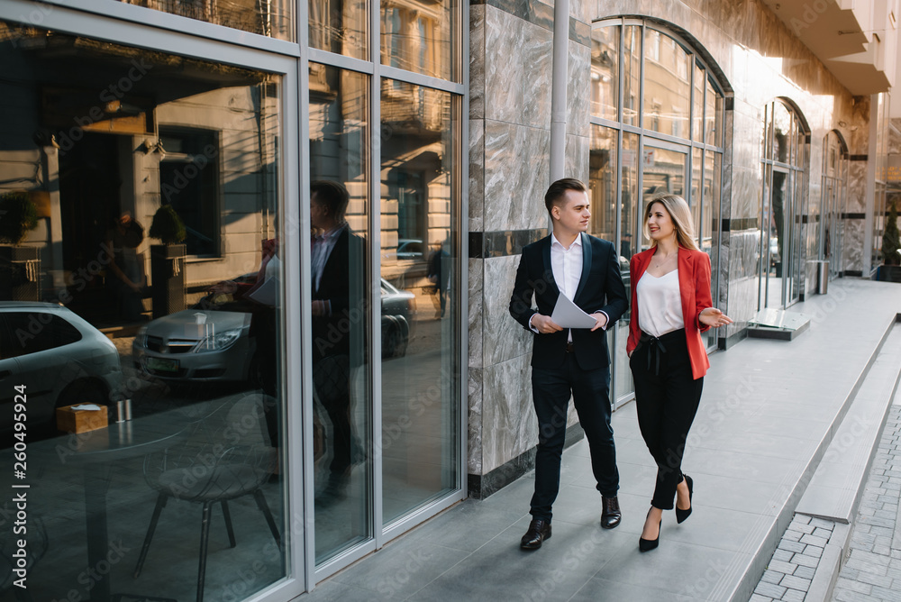 custom made wallpaper toronto digitalTwo confident business colleagues walking on office terrace. Mid adult business man and woman discussing document outdoors on coffee break. Working during break concept