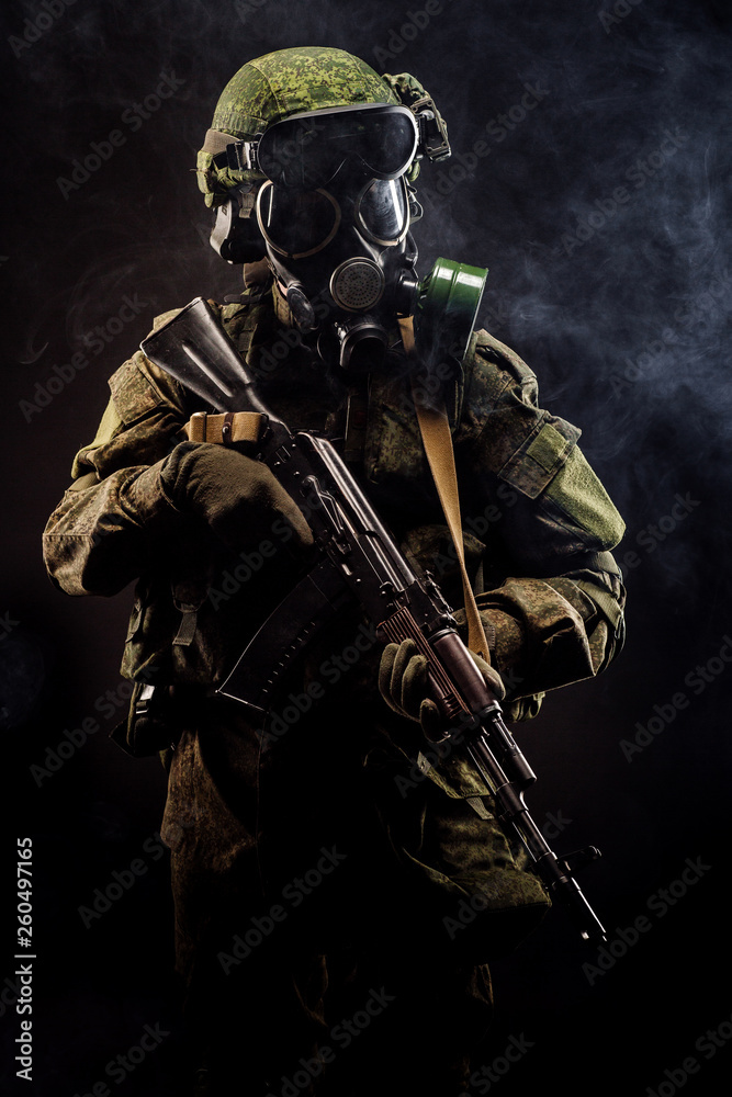 russian special forces soldier with rifle on dark background. army, military and people concept russian special forces soldier with rifle on dark background. army, military and people concept