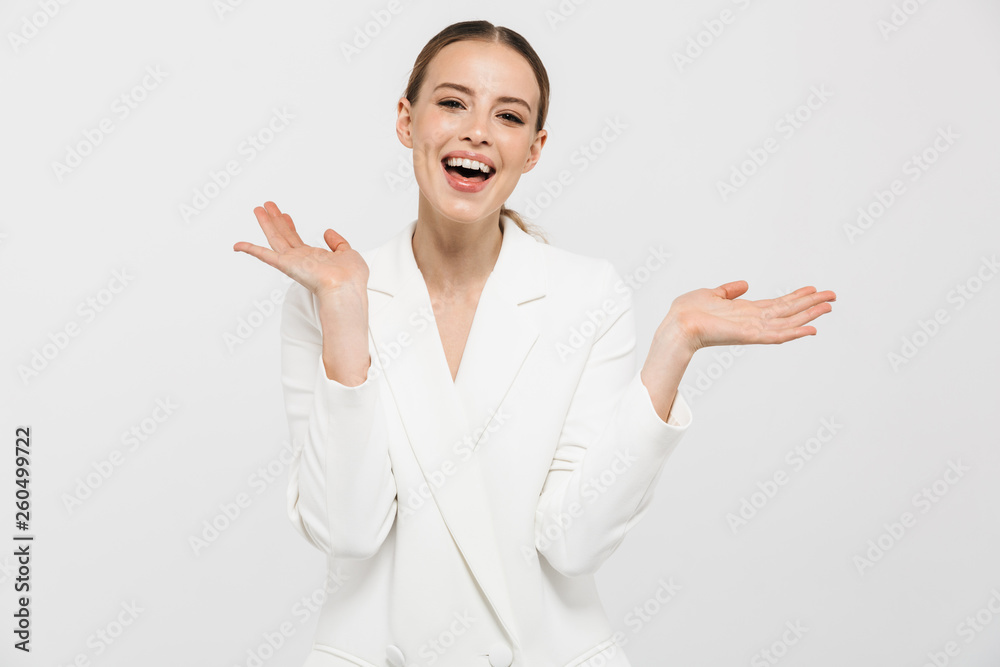 Beautiful happy woman posing isolated over white wall background. Beautiful happy woman posing isolated over white wall background.