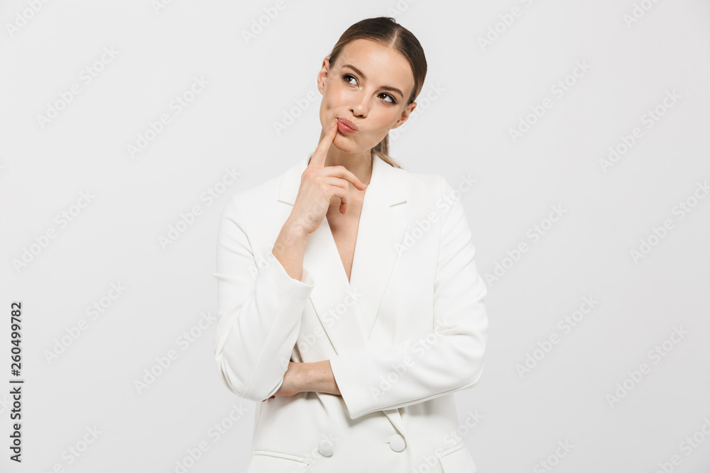 Beautiful thinking woman posing isolated over white wall background. Beautiful thinking woman posing isolated over white wall background.