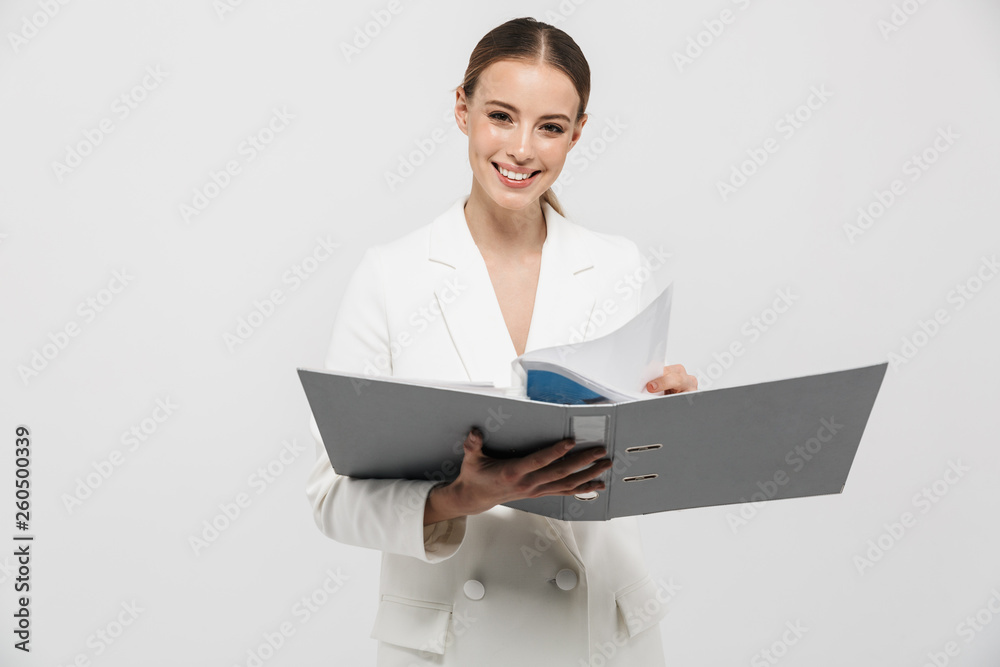 Beautiful amazing woman posing isolated over white wall background holding folder. Beautiful amazing woman posing isolated over white wall background holding folder.