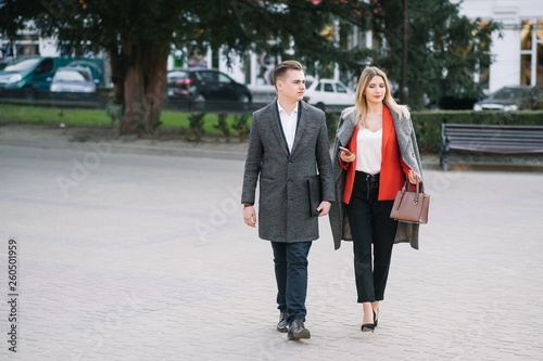 Young business people walking together along the street