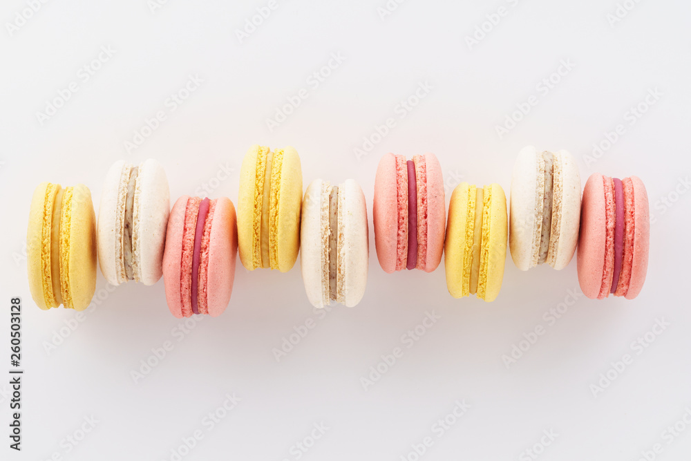 Row of colorful macarons on white background. Row of colorful macarons on white background.