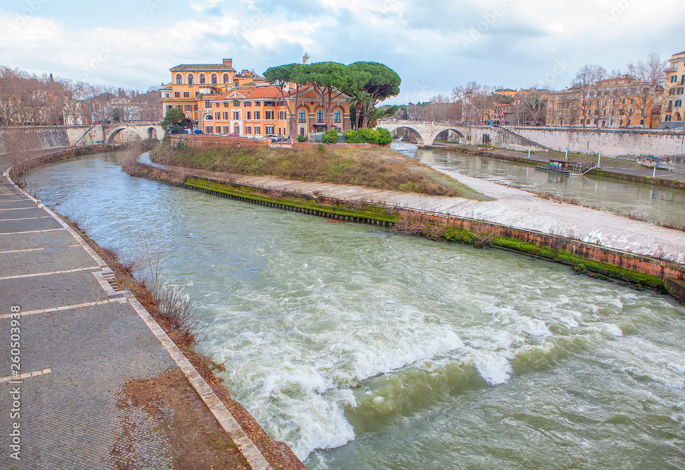Flowing water of tiber river and Isola Tiberina