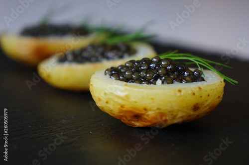 black caviar served on potato 