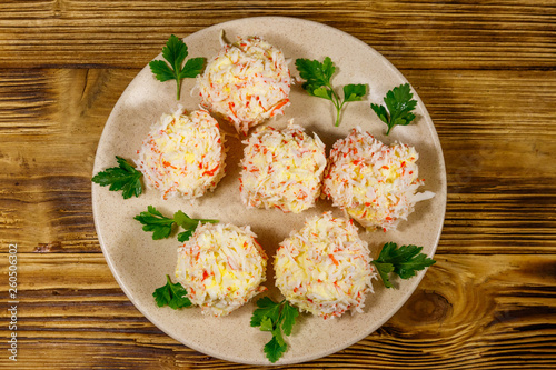 Appetizer of crab-cheese balls on wooden table. Top view