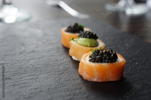 black caviar served on canape with salmon and avocado 