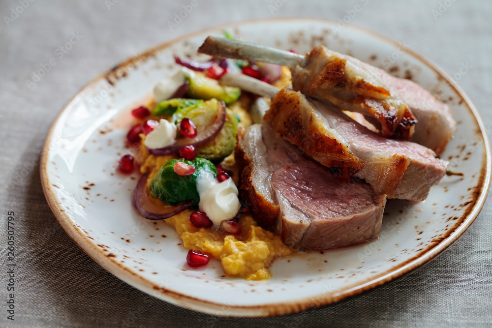 Lamb with pumpkin puree, brussel sprouts and pomegranate Lamb with pumpkin puree, brussel sprouts and pomegranate