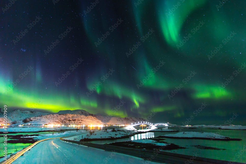 Northern lights in winter time in Norway, amazing view at night in Norway with a bridge