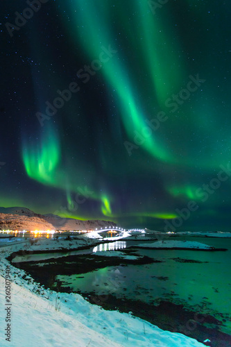 Northern lights in winter time in Norway, amazing view at night in Norway with a bridge in Lofoten islands