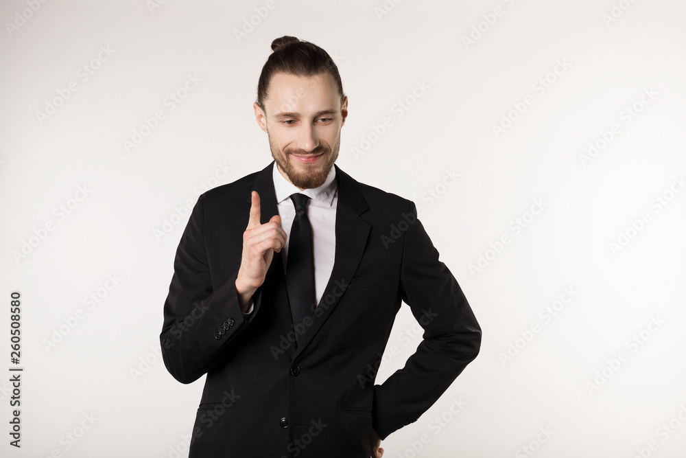 Happy beautiful bearded guy with good-looking hairstyle, wearing black suit and tie Happy beautiful bearded guy with good-looking hairstyle, wearing black suit and tie