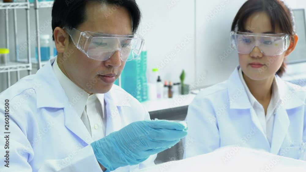 Asian pharmacist are experimenting with chemicals compound and absorb liquid the test tube. Concept of pharmacy, science, testing development and lab industry. Asian pharmacist are experimenting with chemicals compound and absorb liquid the test tube. Concept of pharmacy, science, testing development and lab industry.