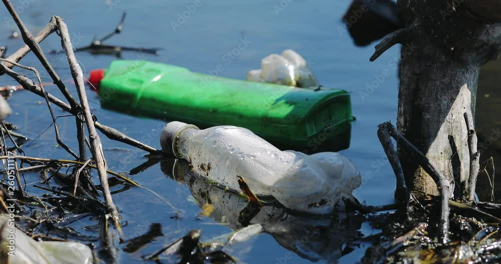 Environmental contamination. Water pollution old garbage on river surface. Pollution by plastic bottles in the water. Pattern of dirty floating objects in the sea.