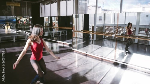 Expressive dancer in bodysuit on tiptoes dancing in class photo