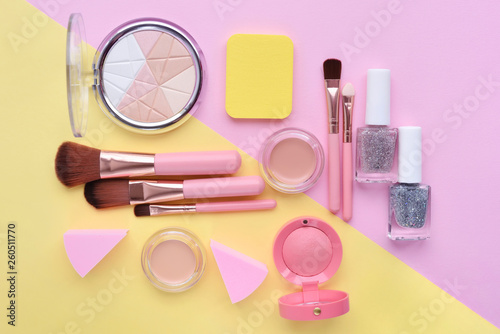 Makeup brush and decorative cosmetics on color background. Minimal style. Top view