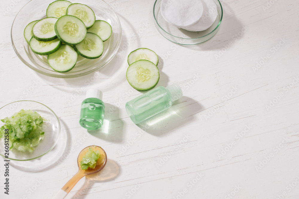 Cosmetic bottle and fresh organic cucumber for skincare. Home spa concept. Cosmetic bottle and fresh organic cucumber for skincare. Home spa concept.