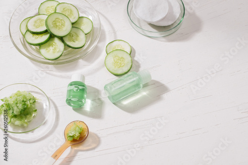 Cosmetic bottle and fresh organic cucumber for skincare. Home spa concept.