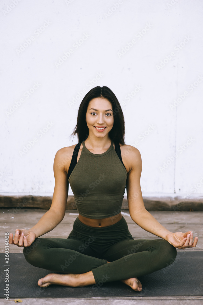 Attractive model in yoga pose on white background in sexual clothes Attractive model in yoga pose on white background in sexual clothes