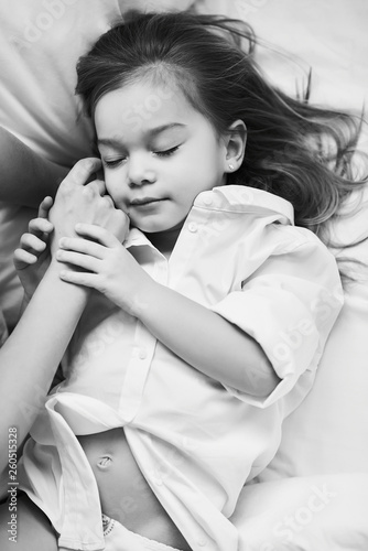 A portrait of beautiful little girl in the morning bedroom