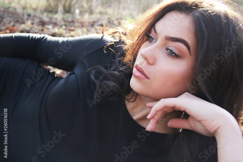 Attractive caucasian model with blue eyes laying on the ground