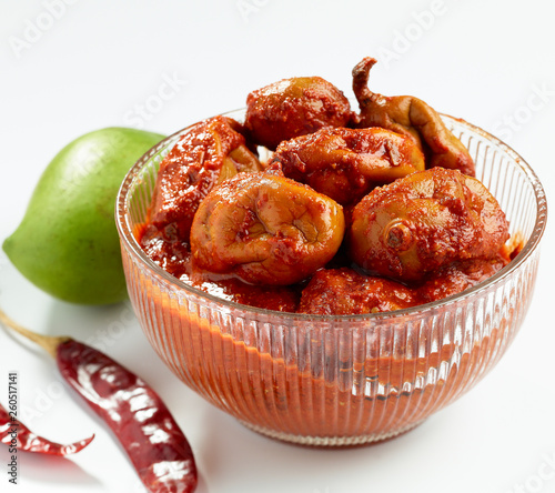 Tender mango spicy pickle served in a bowl photo