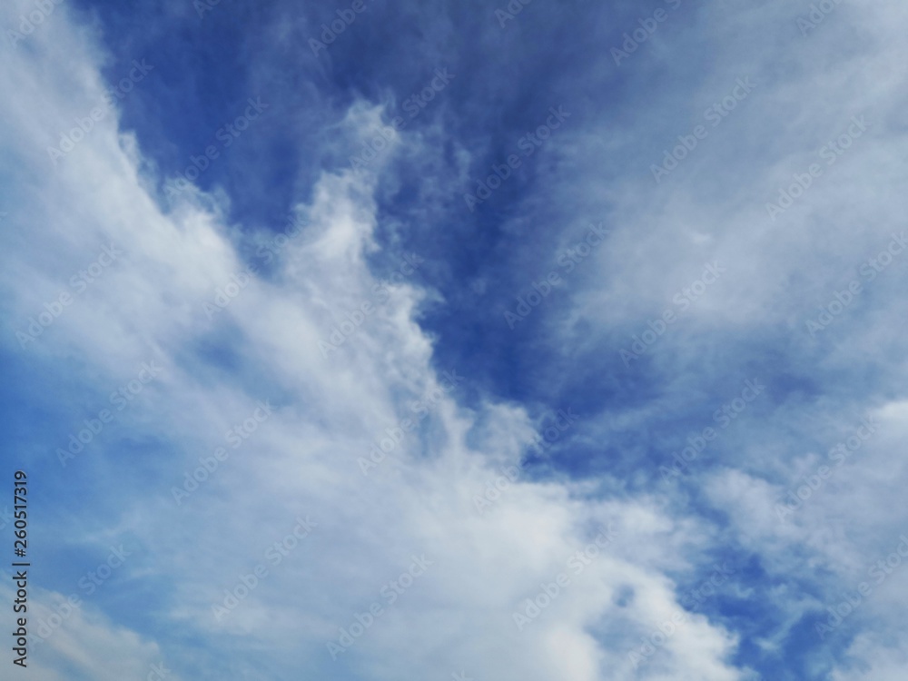 blue sky with white, soft clouds.The sky is clear.