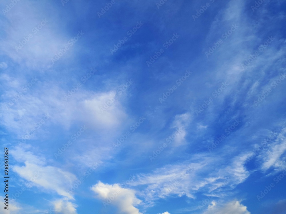 blue sky with white, soft clouds.The sky is clear.